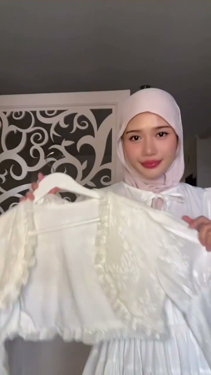 The creator holding up her finished lace piece